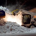 SnowFire plow stacking snow using Bobcat skid steer