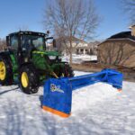 SnowStorm Tractor Snow Plow pushing snow